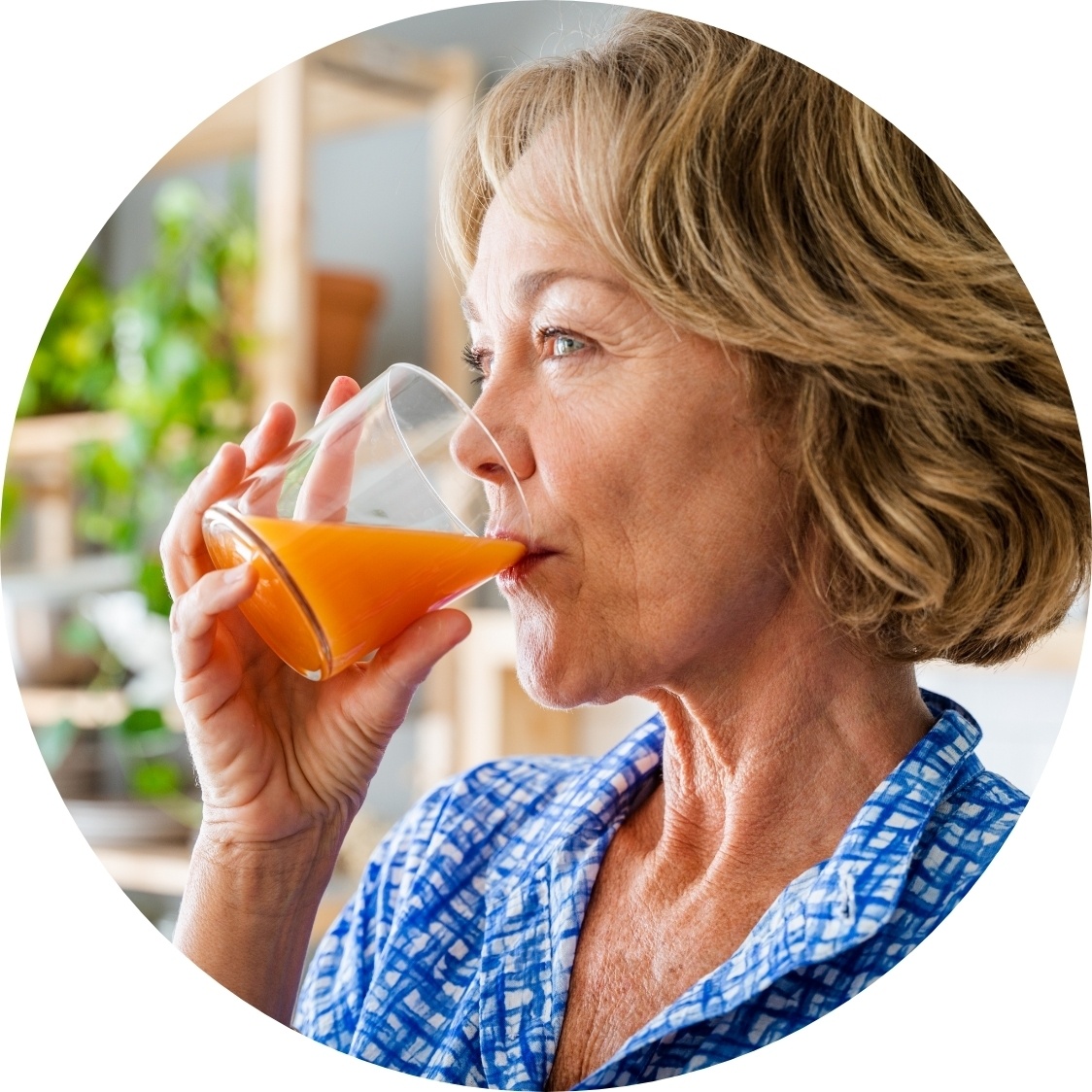 middle aged woman drinking veggie juice