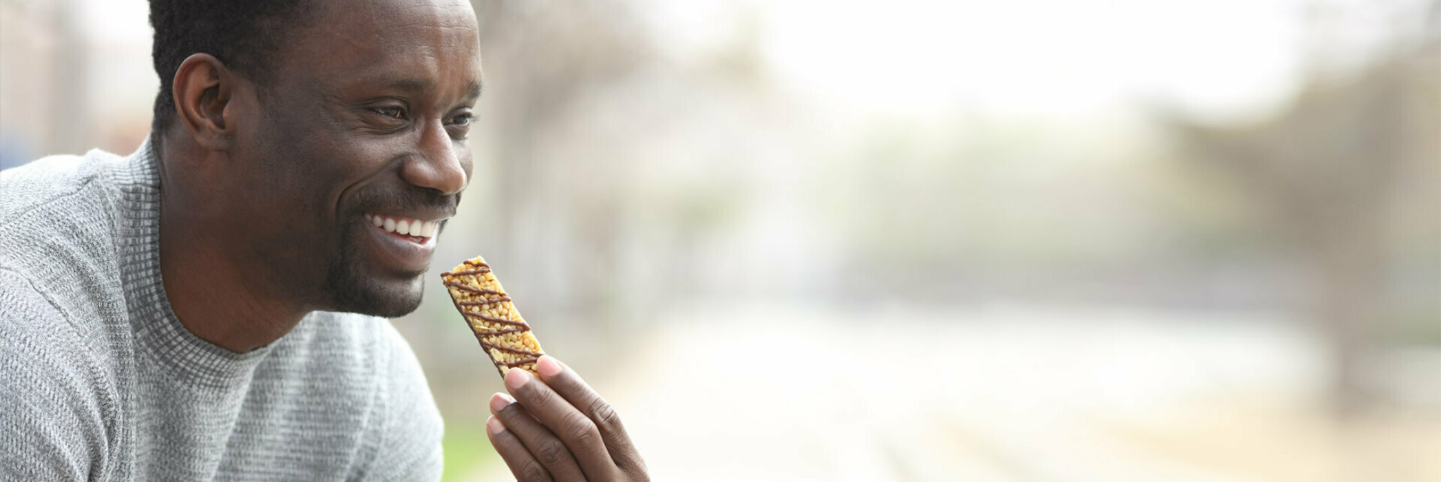 man eating granola bar