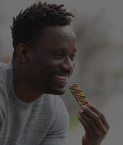 man eating granola bar