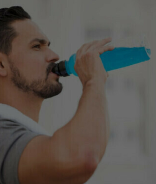 man drinking blue sports drink