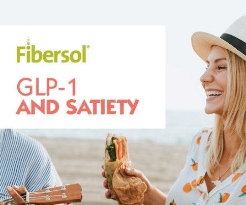 smiling woman snacking on the beach
