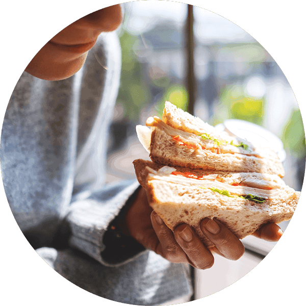 man holding a deli sandwich