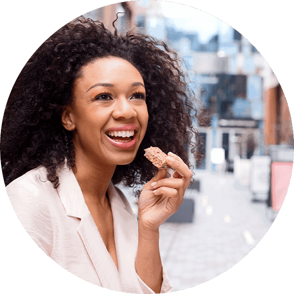happy woman eating granola bar