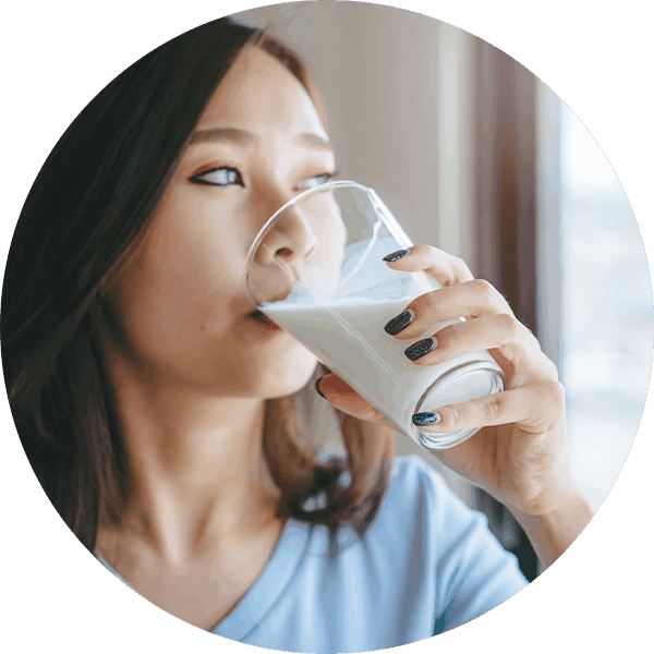 woman drinking a glass of milk